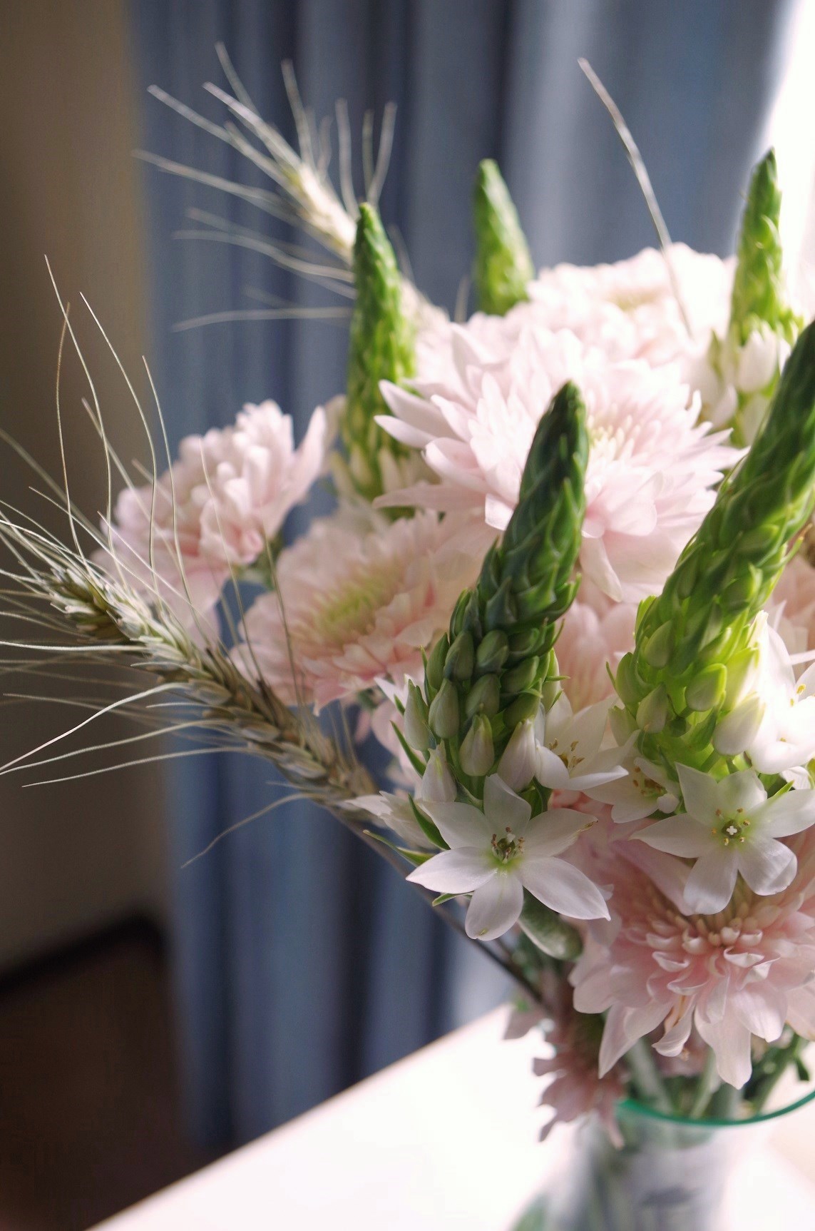 a simple arrangement of flowers; pink and white flowers and wh